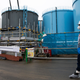 A person walks past storage tanks for contaminated water at the company’s Fukushima Daiichi Nuclear Power Plant